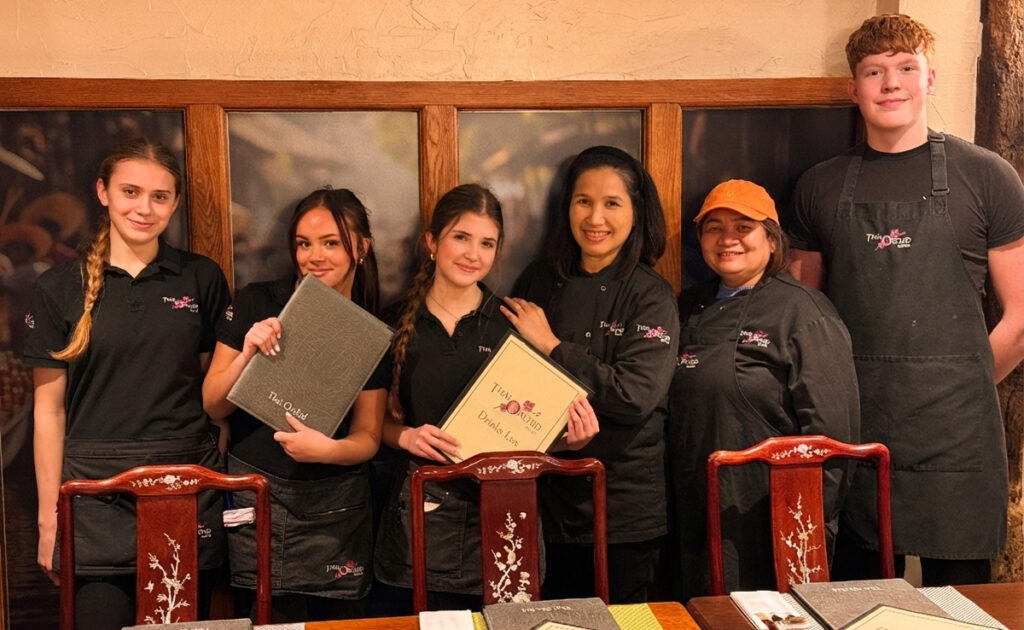 The Thai Orchid Battle team holding menus